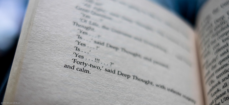 A photo of a copy of the book Hitchhikers' Guide to the Galaxy, showing Deep Thought giving the answer to life, the universe and everything.