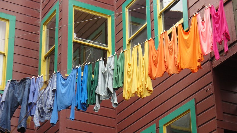 Colourful washing on a line outside a house