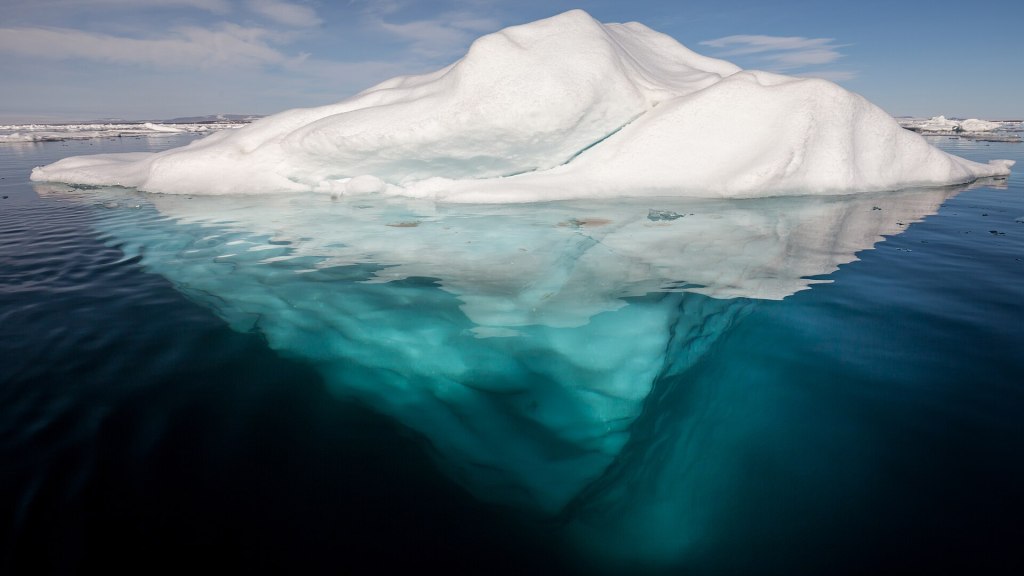 Iceberg in the Arctic. You can see some of the iceberg underwater as well as the part that's above the water.